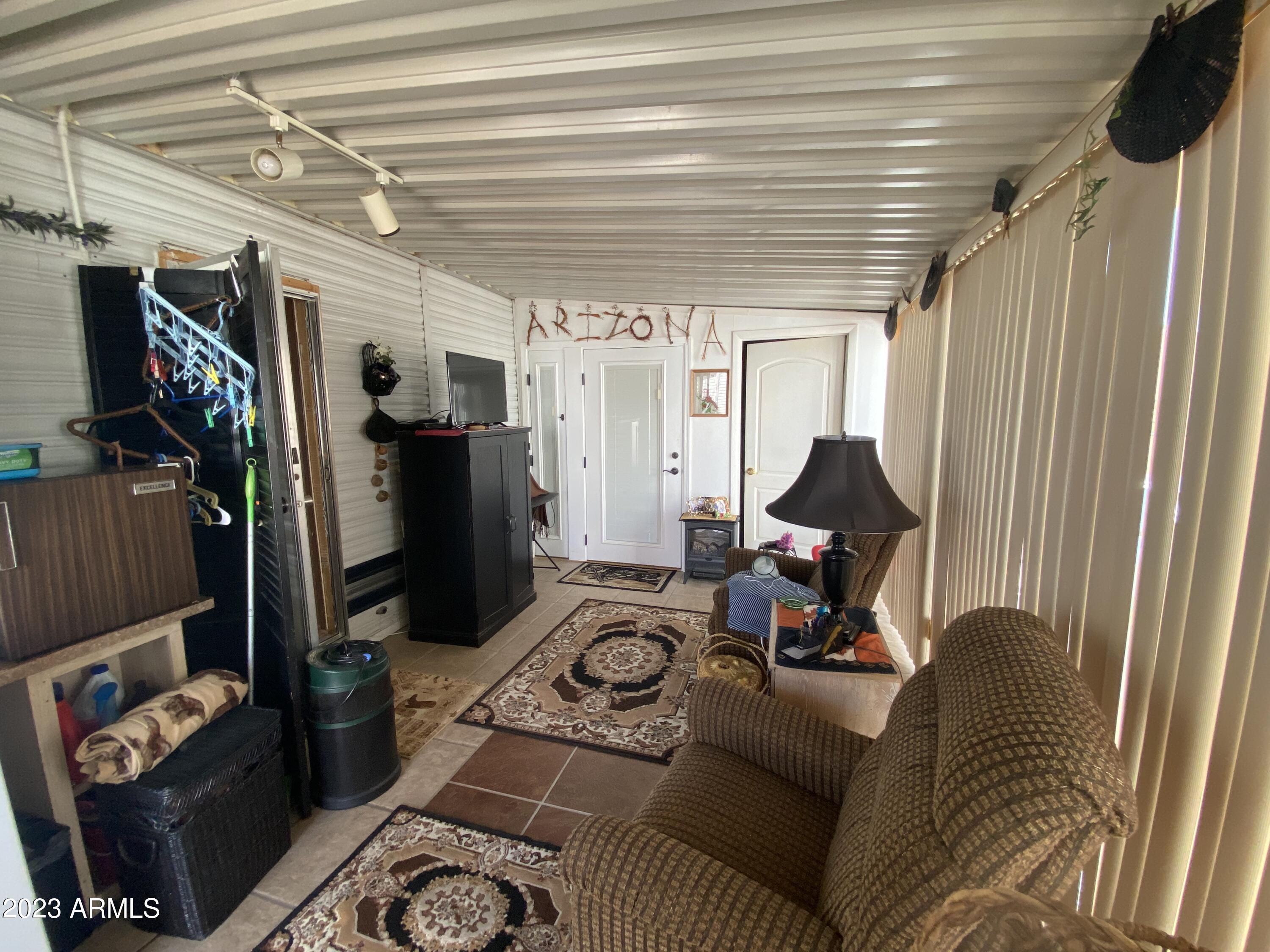 3301 South Goldfield Road Apache Junction, AZ 85119 - Photo 13 of 45 a living room with furniture and a flat screen tv