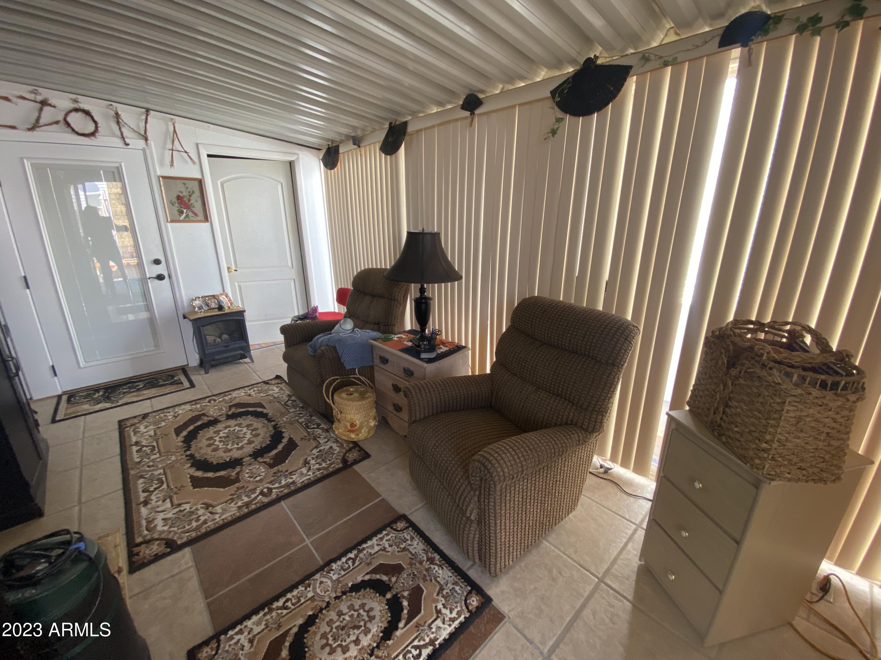 3301 South Goldfield Road Apache Junction, AZ 85119 - Photo 15 of 45 a living room with furniture and a flat screen tv