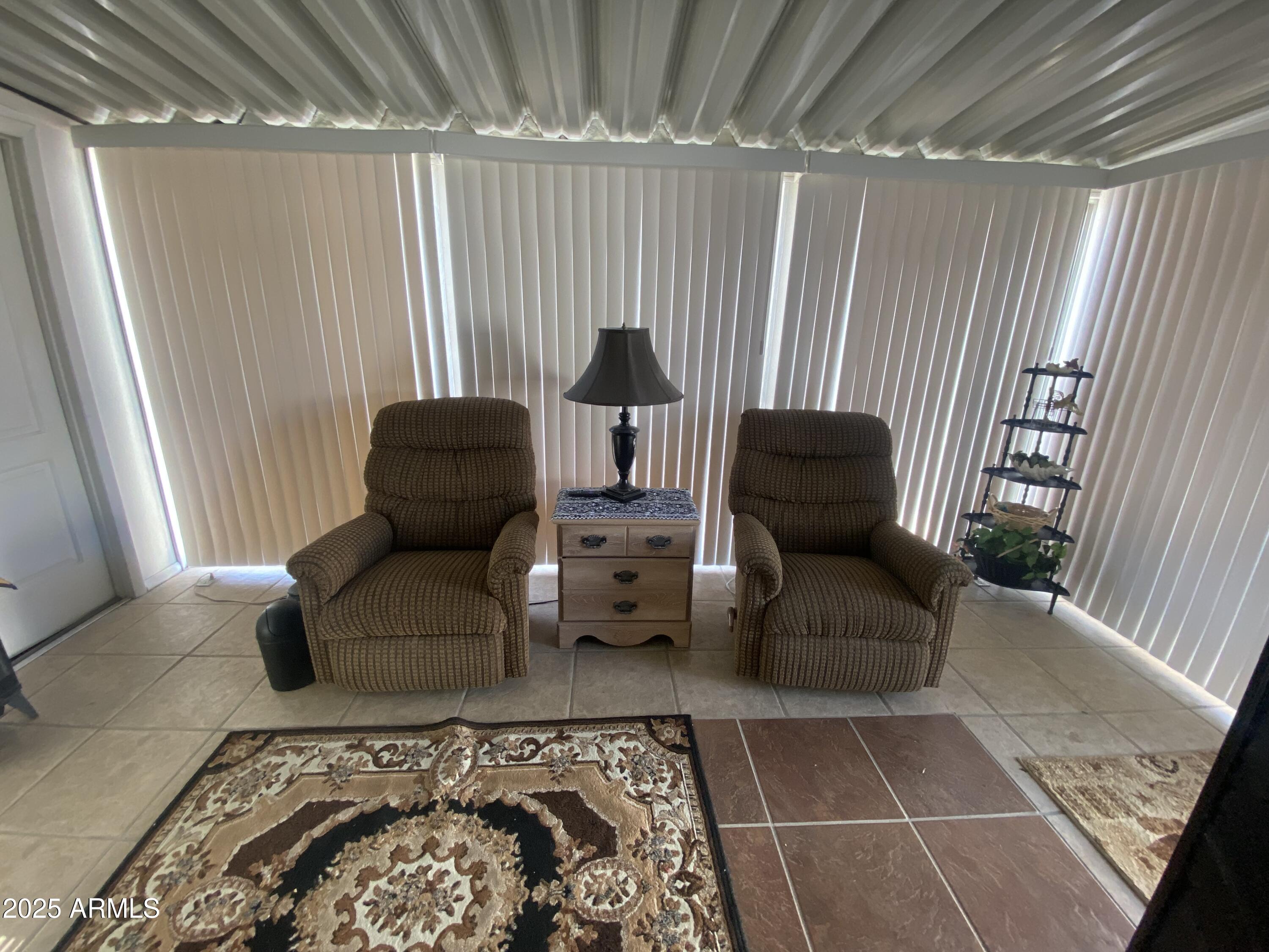 3301 South Goldfield Road Apache Junction, AZ 85119 - Photo 19 of 45 a living room with furniture and a rug
