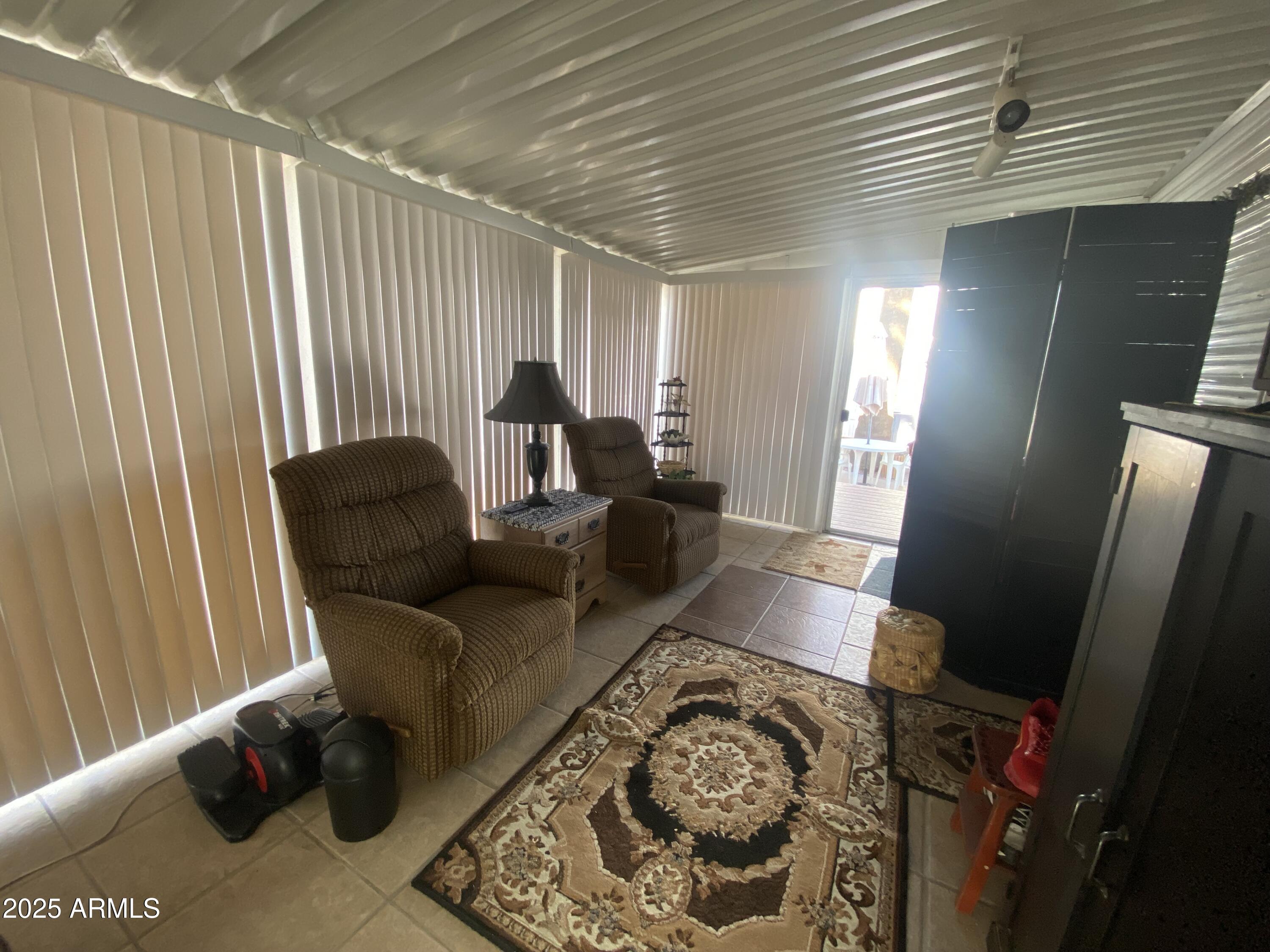 3301 South Goldfield Road Apache Junction, AZ 85119 - Photo 21 of 45 a living room with furniture and a rug