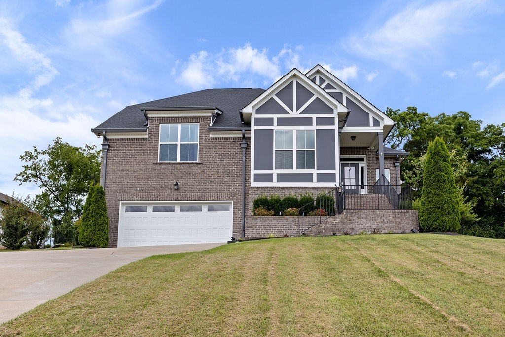 147 Enoch Way Gallatin, TN 37066 - Photo 1 of 60 a front view of a house with a yard and garage