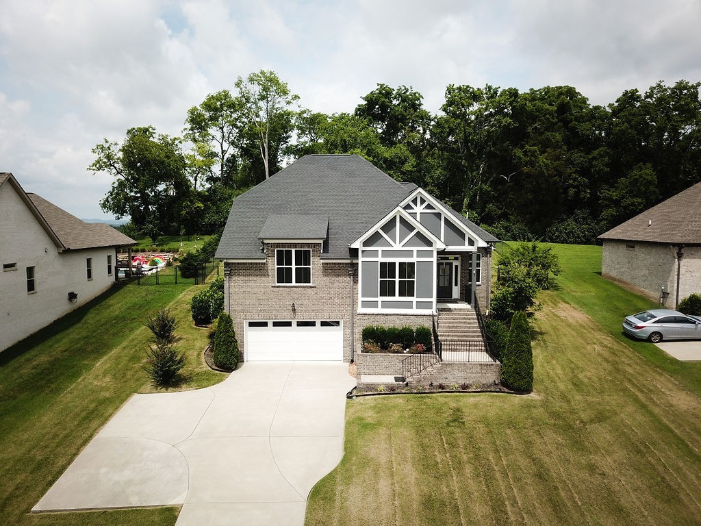 147 Enoch Way Gallatin, TN 37066 - Photo 56 of 60 a view of a white house with a yard plants and large tree