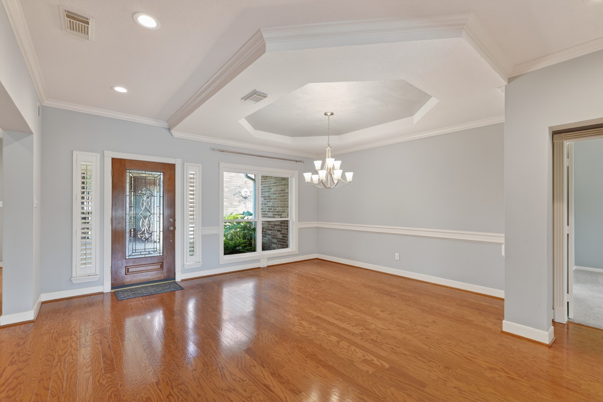 20714 Flora View Court Spring, TX 77379 - Photo 8 of 40 an empty room with wooden floor and windows