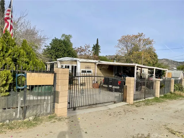a view of a wrought house with a yard