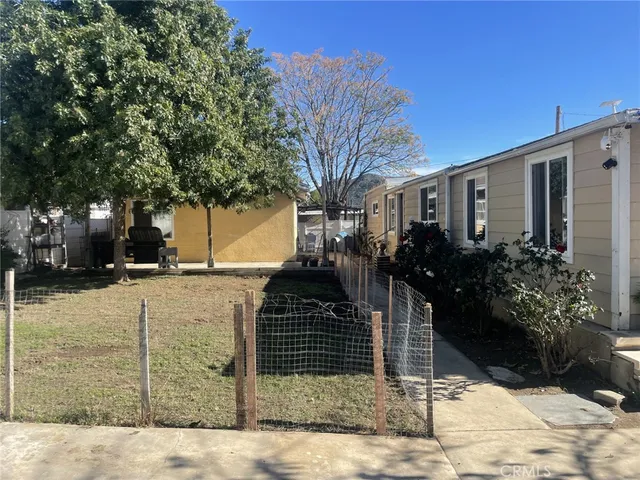 a view of a house with a yard covered with snow