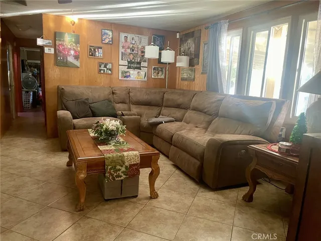 a living room with furniture and a floor to ceiling window