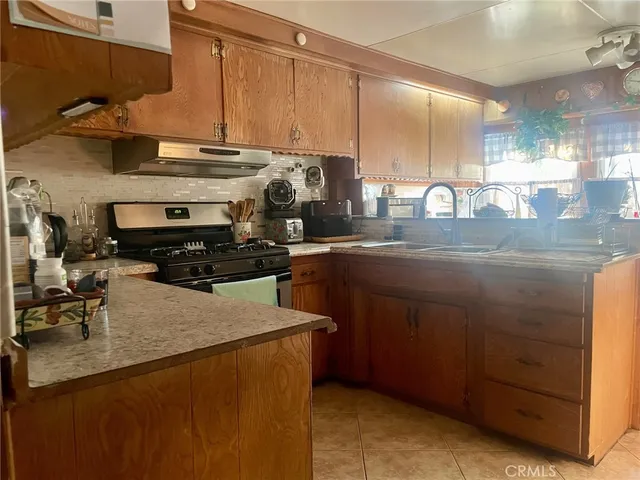 a kitchen with kitchen island granite countertop a sink a counter and cabinets