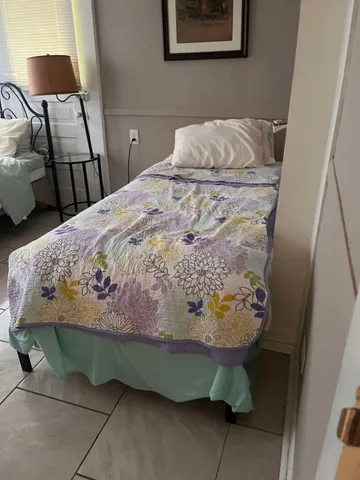 a bedroom with a bed and a chair