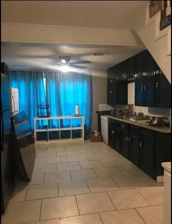 a view of a kitchen with a sink and cabinets