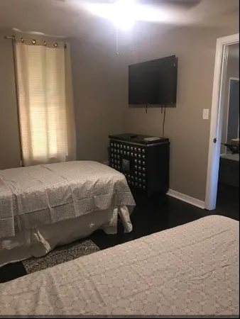 a bedroom with a bed and a flat screen tv