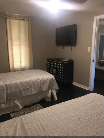 a bedroom with a bed and a flat screen tv