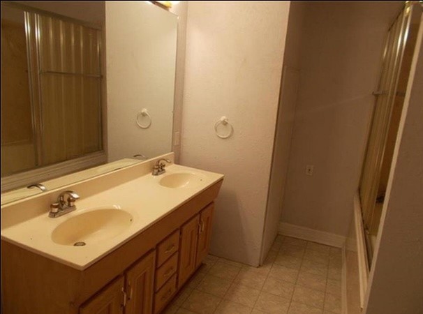 435 East Ave J Silsbee, TX 77656 - Photo 31 of 34 a bathroom with a sink and a mirror