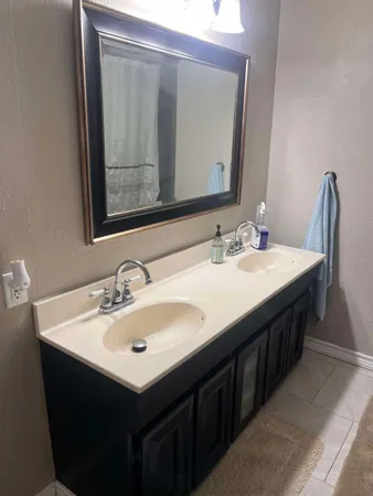 a bathroom with a sink vanity and a mirror