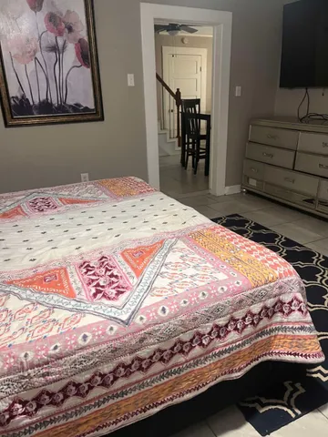 a bedroom with a bed and a painting on the wall