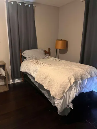 a bedroom with a bed and a window