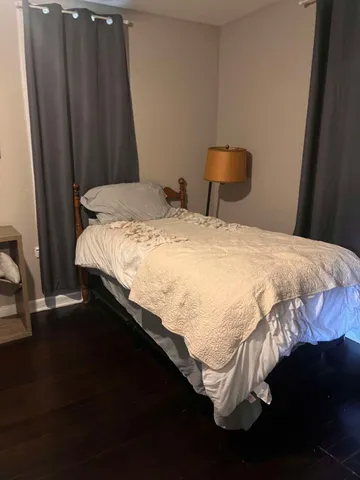 a bedroom with a bed and a window