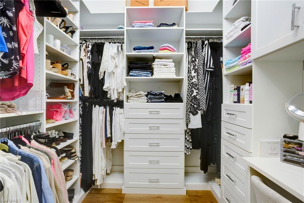 11413 Jacaranda Drive Naples, FL 34120 - Photo 20 of 50 a view of walk in closet with clothes and shoes