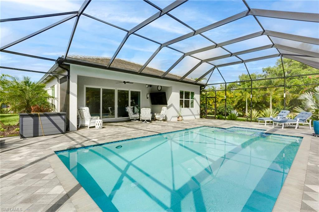 11413 Jacaranda Drive Naples, FL 34120 - Photo 31 of 50 a view of a swimming pool with a patio