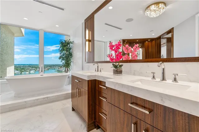 a bathroom with a sink a vanity and a large mirror