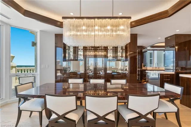 a dining room with furniture a chandelier and wooden floor