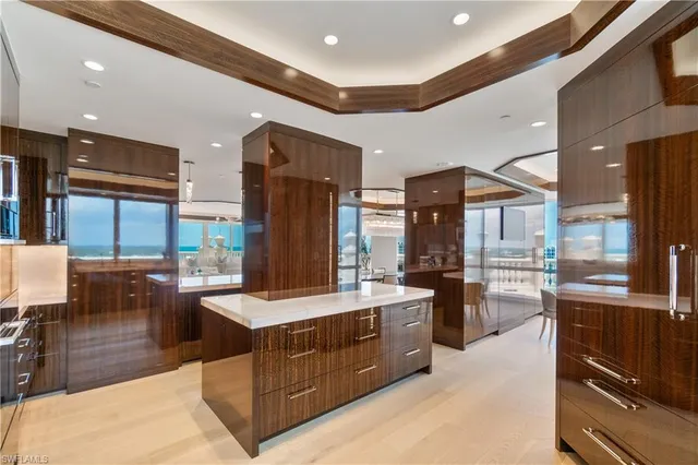 a large kitchen with stainless steel appliances kitchen island granite countertop a refrigerator and a stove