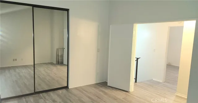 a view of an empty room and wooden floor