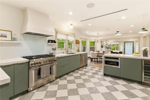 a kitchen with stainless steel appliances a sink stove and cabinets