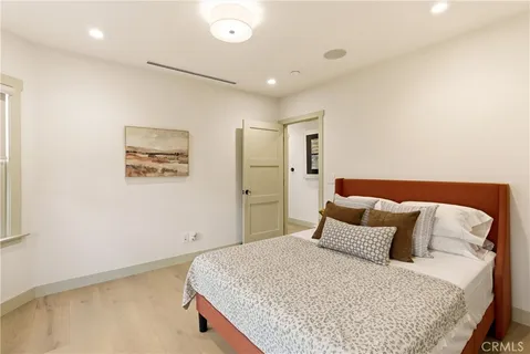 a spacious bedroom with a bed and window