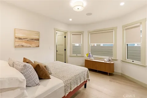 a bedroom with a bed and painting on the wall