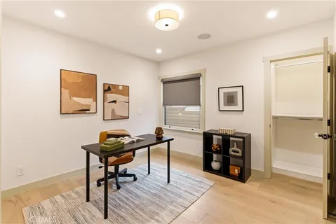 a bedroom with a bed and a large window