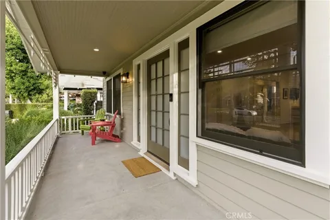 a view of a porch with a table and chairs