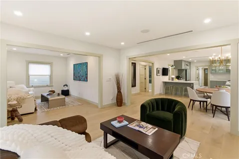 a dining room with furniture a chandelier and wooden floor