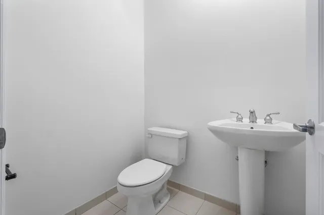 a bathroom with a sink toilet and a mirror