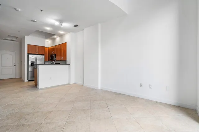 a view of a kitchen with a refrigerator a microwave and a sink
