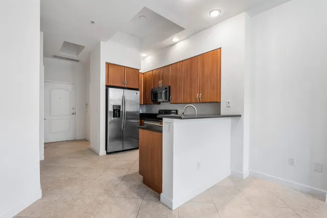 a kitchen with refrigerator cabinets and a sink