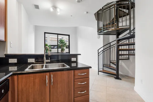 a kitchen with sink and a window