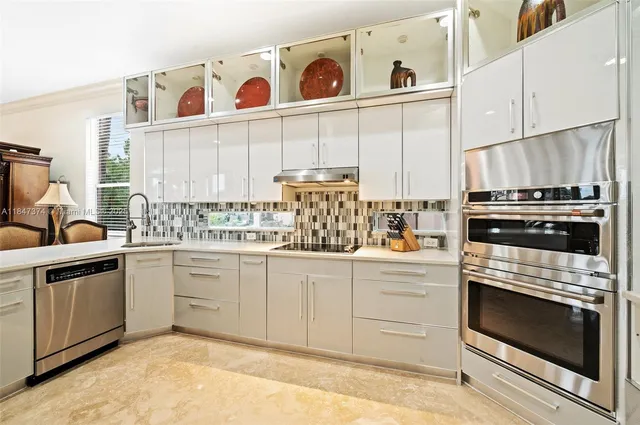 a kitchen with granite countertop cabinets stainless steel appliances and wooden floor
