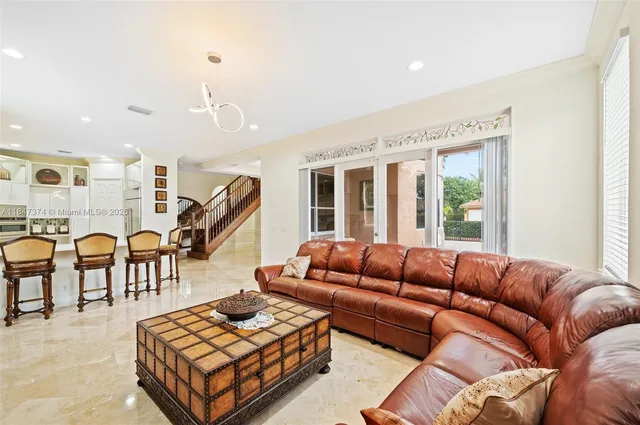 a living room with furniture a rug and a chandelier