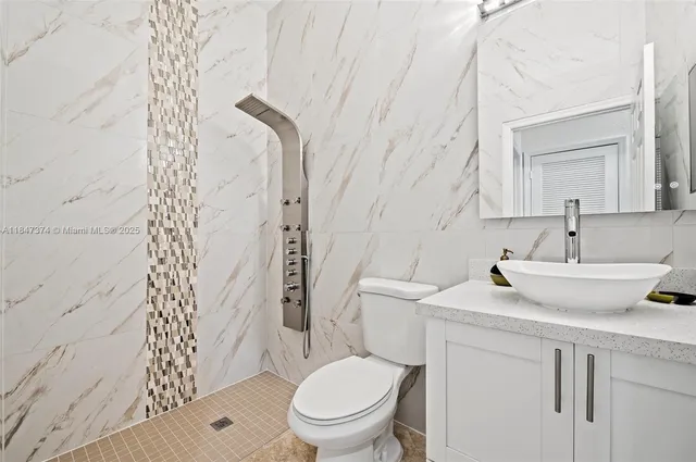 a bathroom with a sink toilet and shower