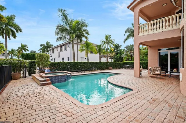 a view of a house with swimming pool and sitting area