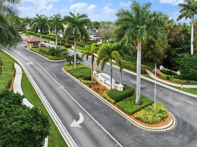 an aerial view of residential houses with outdoor space and river