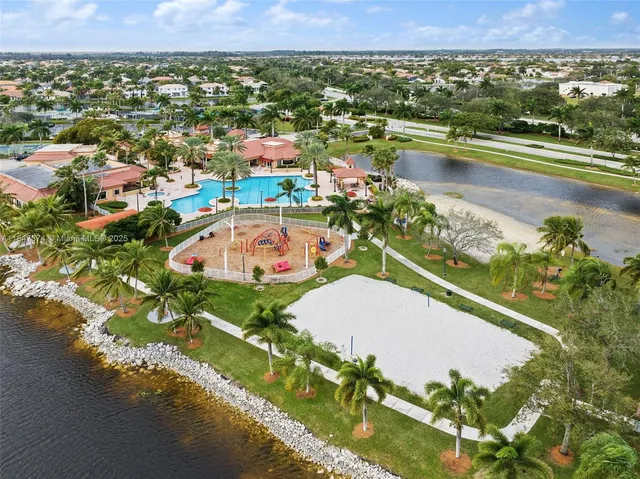 a view of a swimming pool with a slide and bench