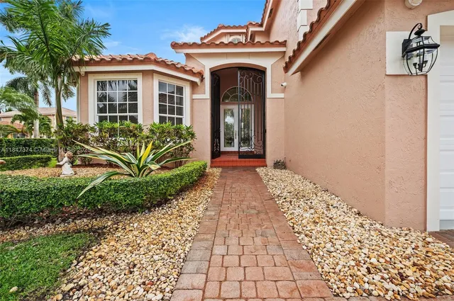 a front view of a house with garden