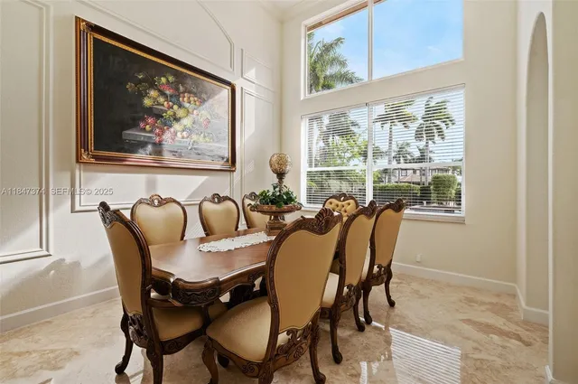 a view of a dining room with furniture a rug and wooden floor