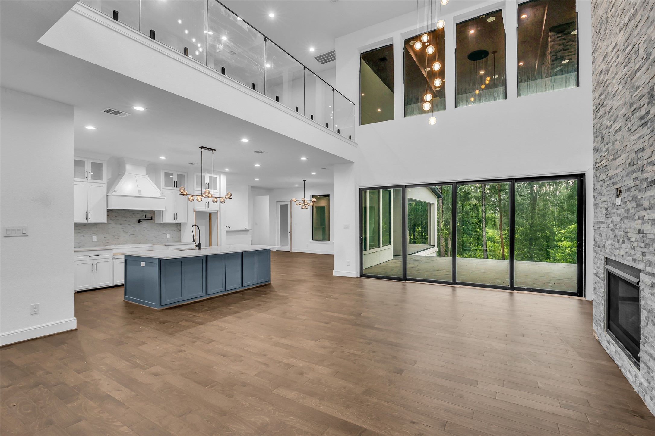 2 Deer Ridge Estates Boulevard Houston, TX 77339 - Photo 4 of 25 Main living area view from the front door, featuring a huge patio door overlooking the outdoor living space and an open kitchen layout.