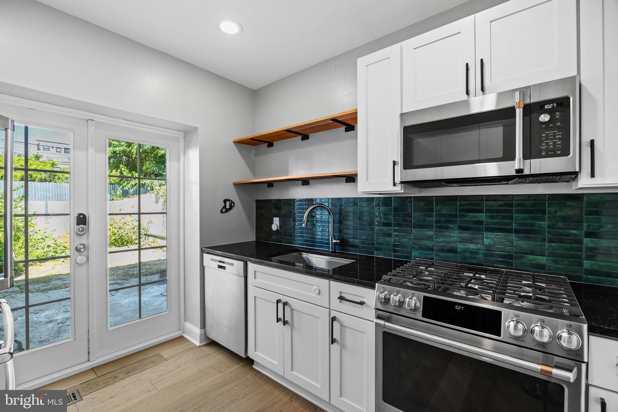 2026 North Lawrence Street Philadelphia, PA 19122 - Photo 12 of 34 a kitchen with stainless steel appliances granite countertop a stove and a microwave