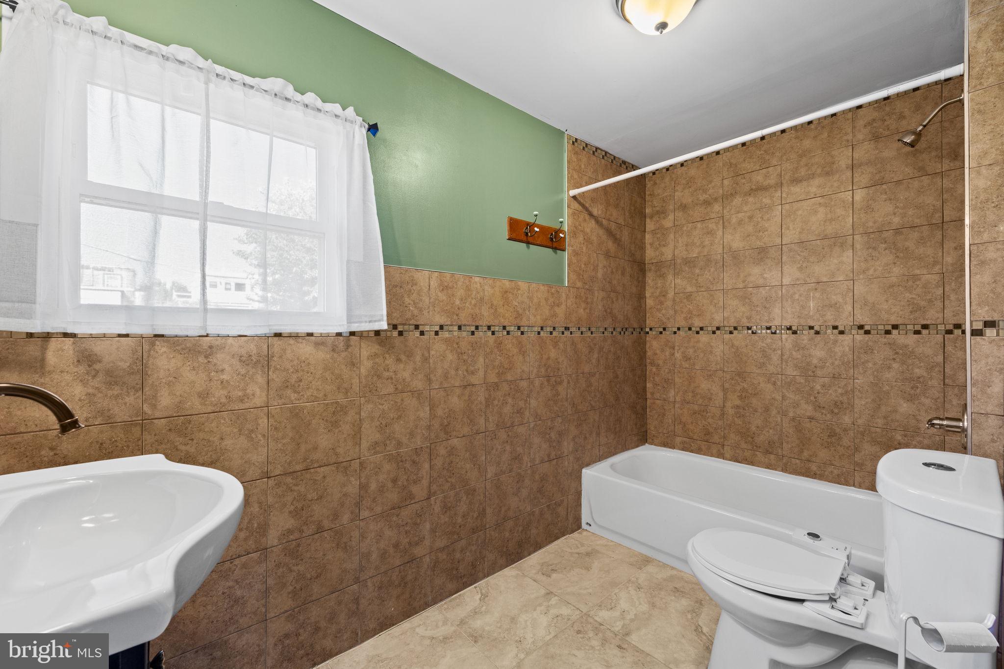 2026 North Lawrence Street Philadelphia, PA 19122 - Photo 22 of 34 a bathroom with a sink a toilet and shower
