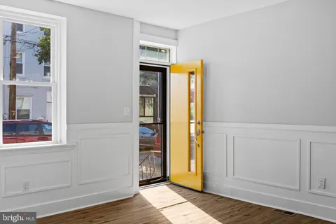 a view of front door with wooden floor