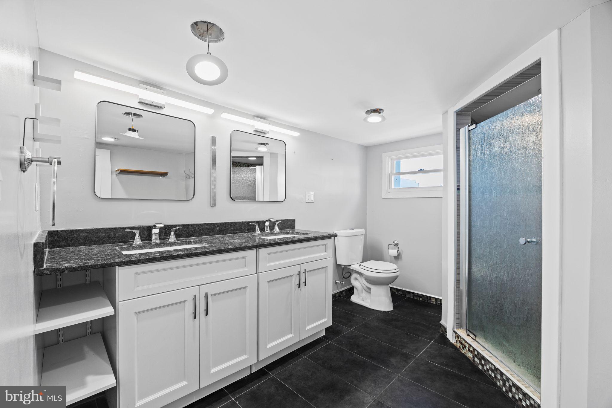 2026 North Lawrence Street Philadelphia, PA 19122 - Photo 31 of 34 a bathroom with a granite countertop sink a toilet and a mirror