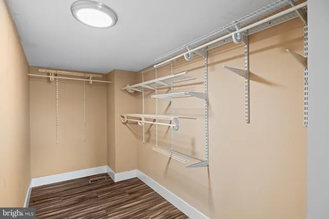 a bathroom with a granite countertop sink a toilet and a mirror